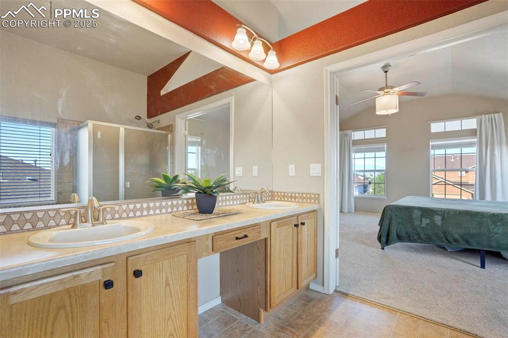 Image 30 of 50: Ensuite bathroom with a shower stall, double vanity, plenty of natural ligh