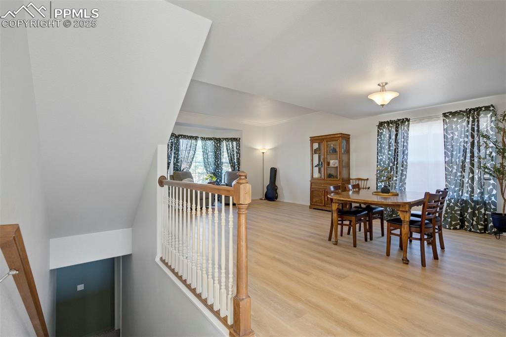 Image 39 of 50: Dining area with light wood-style flooring and healthy amount of natural li