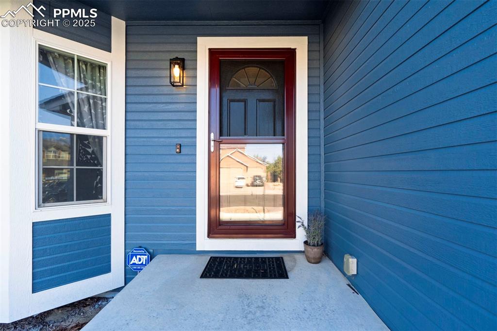 Image 4 of 50: View of exterior entry with a porch