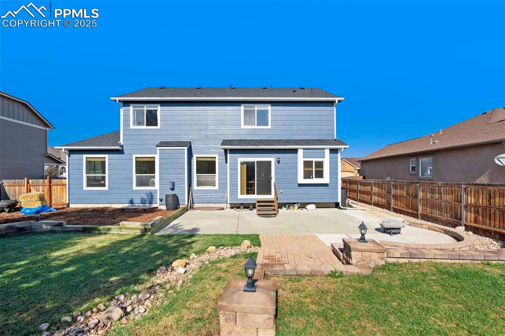 Image 42 of 50: Back of house with a patio, a fenced backyard, and entry steps