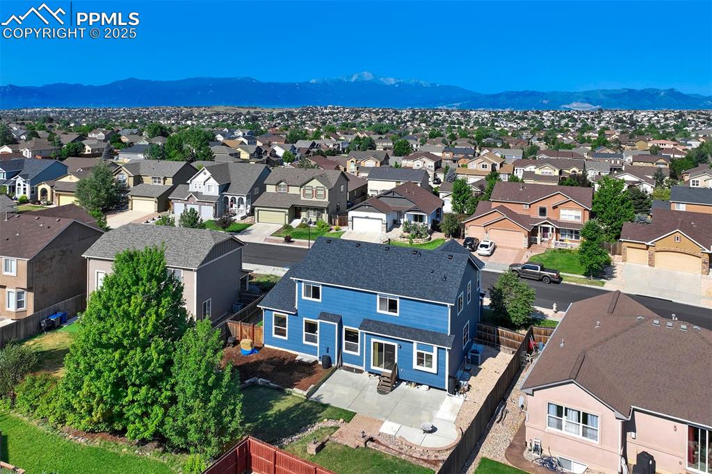 Image 47 of 50: Aerial perspective of suburban area with a mountainous background