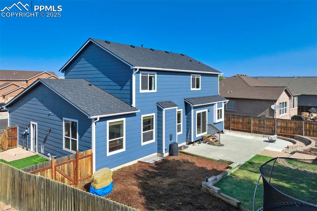 Image 48 of 50: Back of property with roof with shingles, a fenced backyard, a patio area,