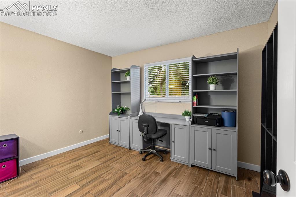 Image 10 of 23: Spacious bedroom with built-ins and natural light.