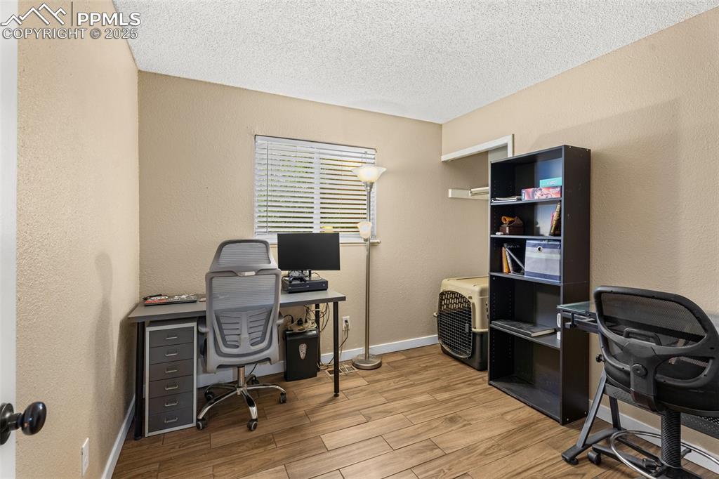Image 11 of 23: Private office space with built-in shelving.