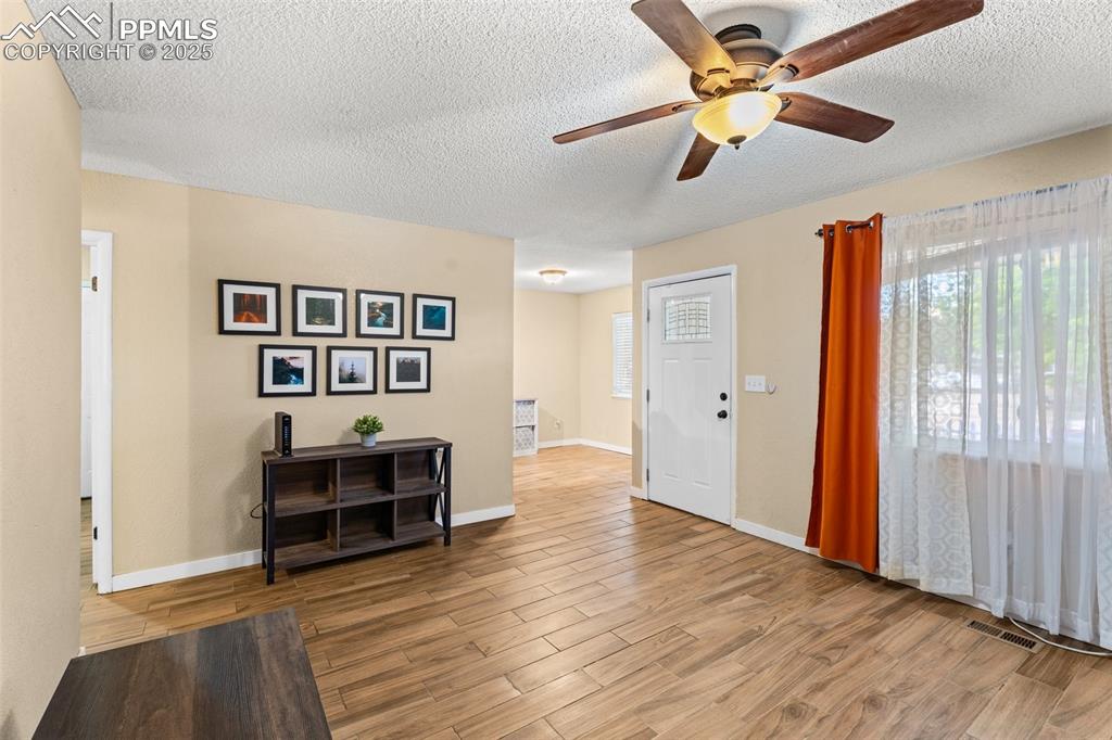 Image 6 of 23: Bright living room with wood floors and natural light.