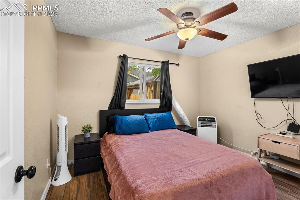 Image 9 of 23: Comfortable bedroom with ceiling fan and TV.