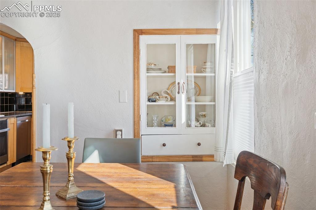 Image 11 of 37: Dining room featuring a textured wall and arched walkways