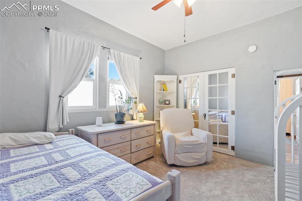 Image 18 of 37: Bedroom featuring light carpet, a ceiling fan, and french doors