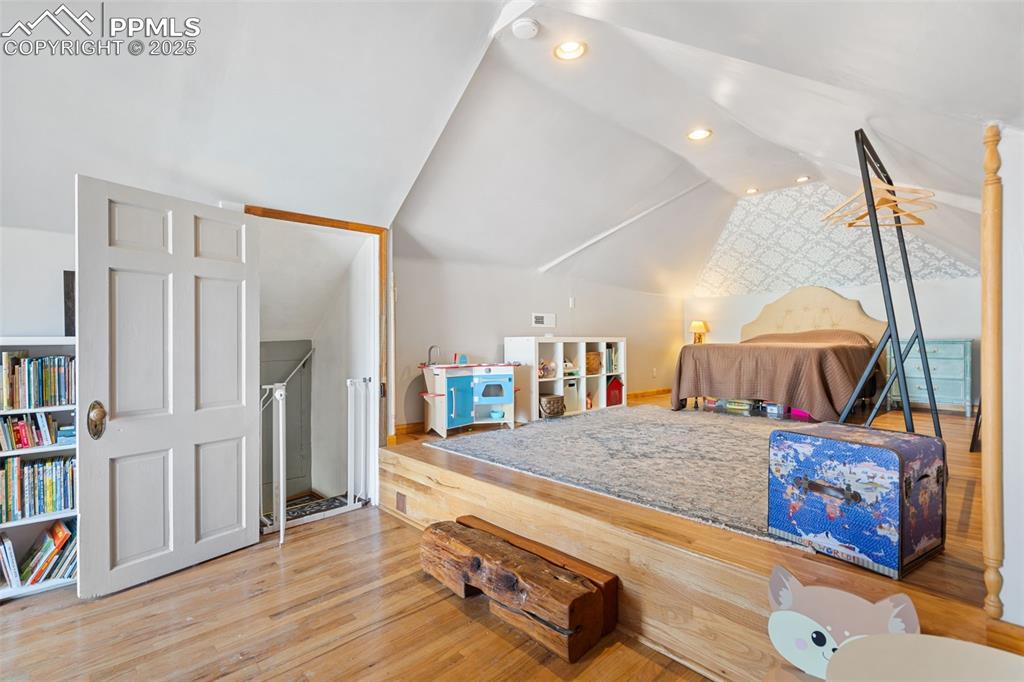 Image 23 of 37: Game room with vaulted ceiling, wood finished floors, and recessed lighting