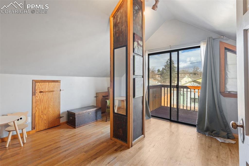 Image 25 of 37: Bonus room with vaulted ceiling and light wood-style floors