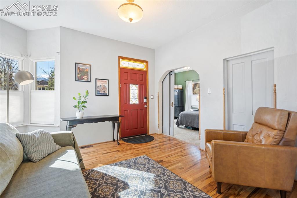 Image 8 of 37: Living area featuring light wood-style floors and arched walkways