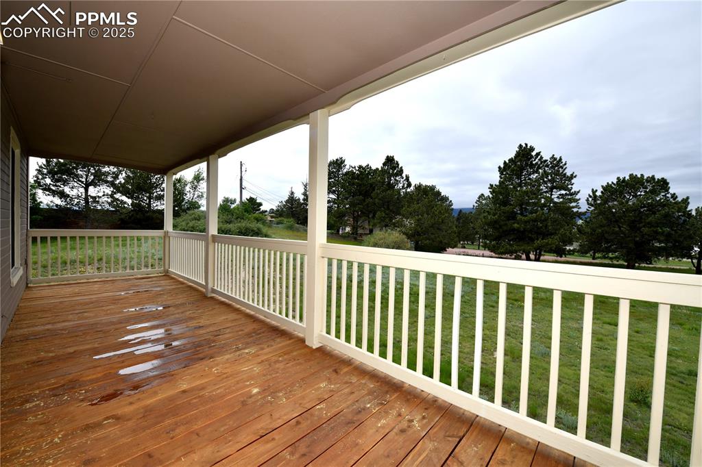 Image 6 of 36: Wooden terrace featuring a yard