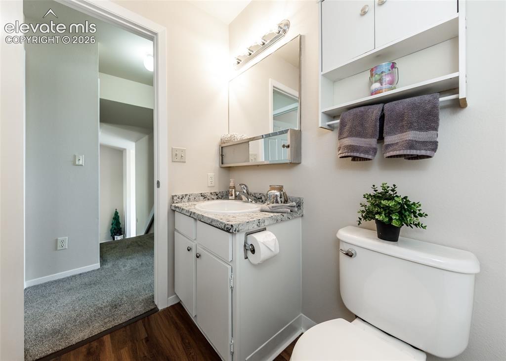 Image 26 of 36: Bathroom with a white vanity cabinet, undermount sink, and a speckled count