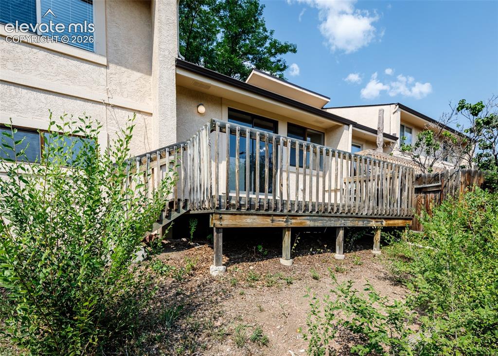 Image 35 of 36: Expansive wooden deck with a slatted railing, providing outdoor access from