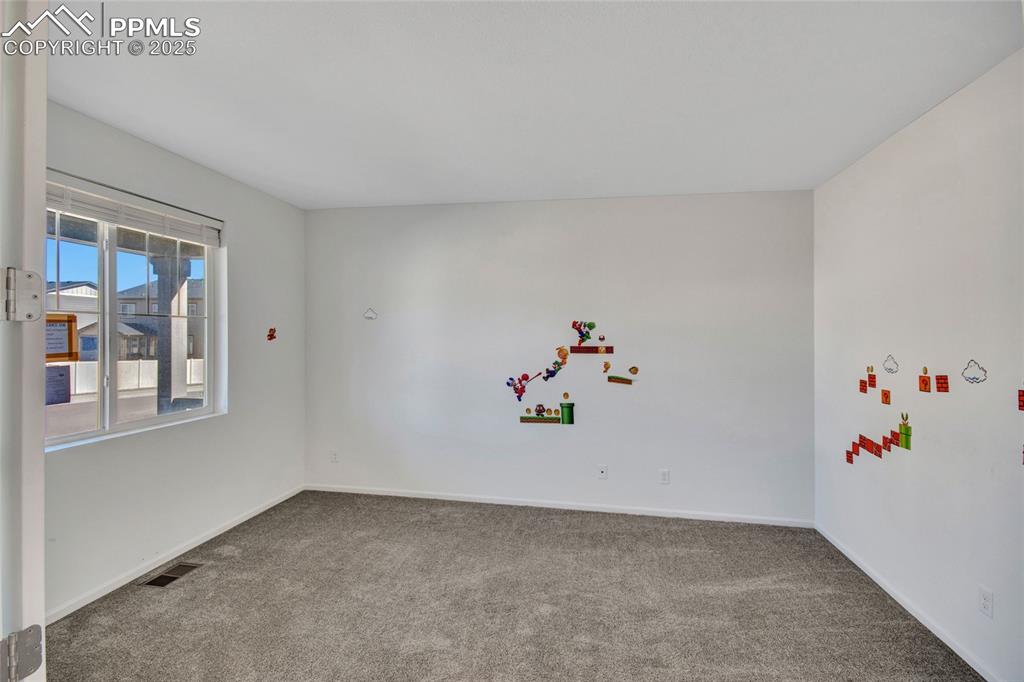 Image 12 of 46: Empty room featuring carpet floors and baseboards