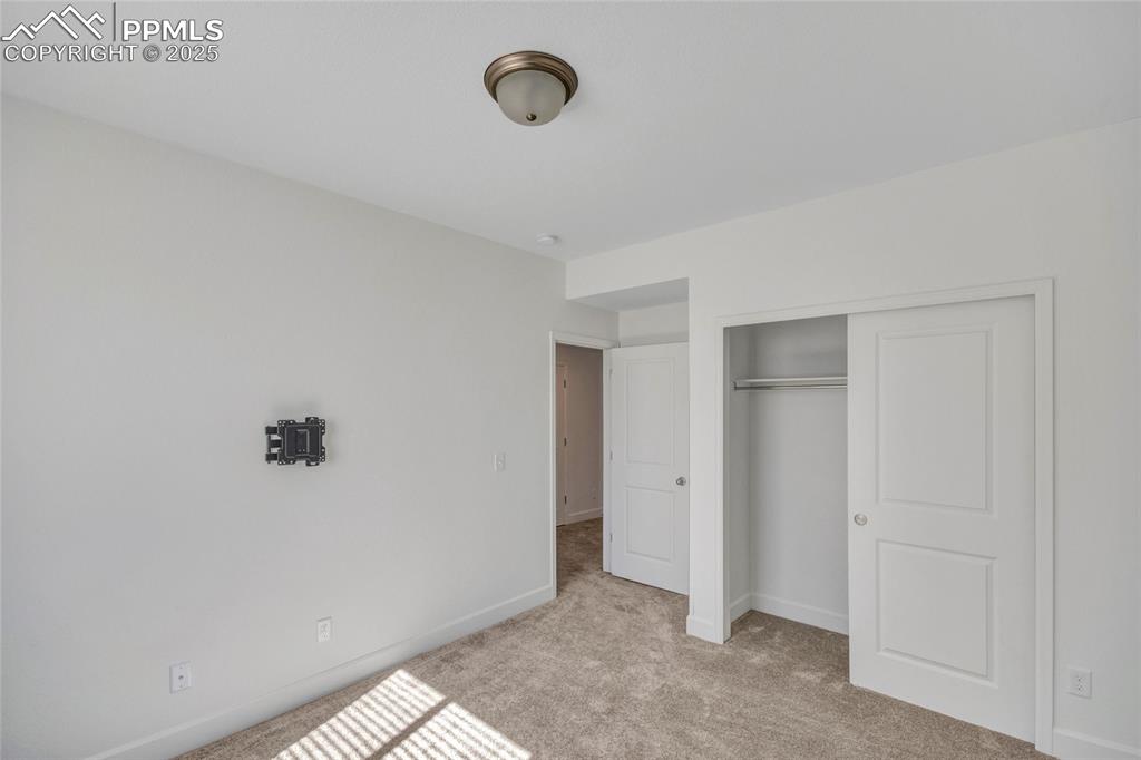 Image 24 of 46: Unfurnished bedroom featuring light carpet and a closet