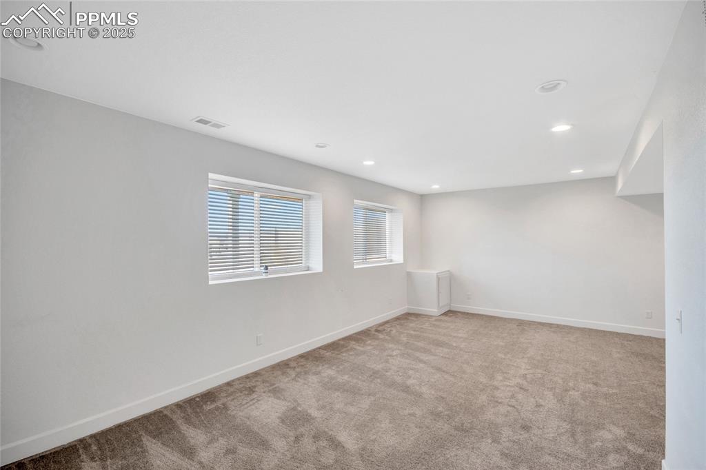 Image 25 of 46: Spare room featuring light colored carpet and recessed lighting