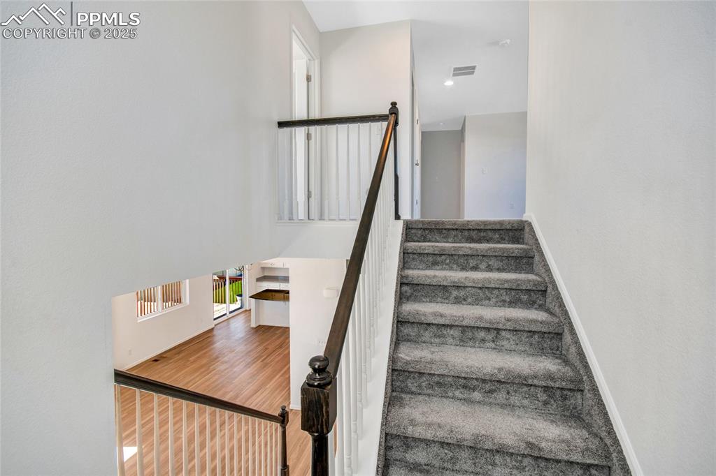 Image 28 of 46: Stairway featuring wood finished floors and baseboards