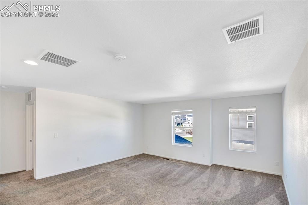 Image 29 of 46: Unfurnished room with light carpet