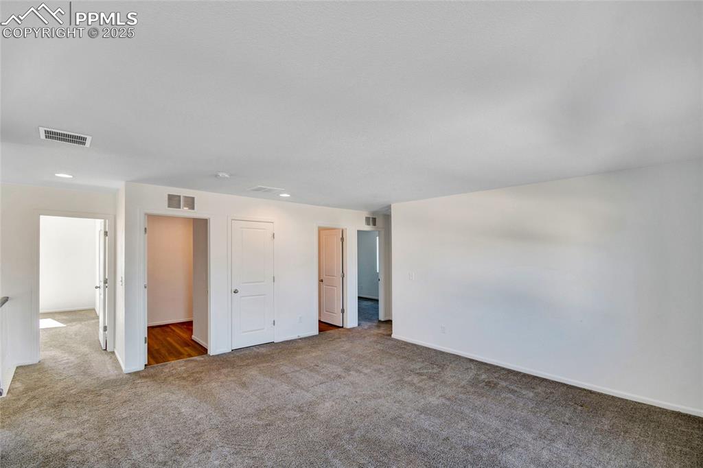 Image 30 of 46: Carpeted spare room with baseboards and recessed lighting
