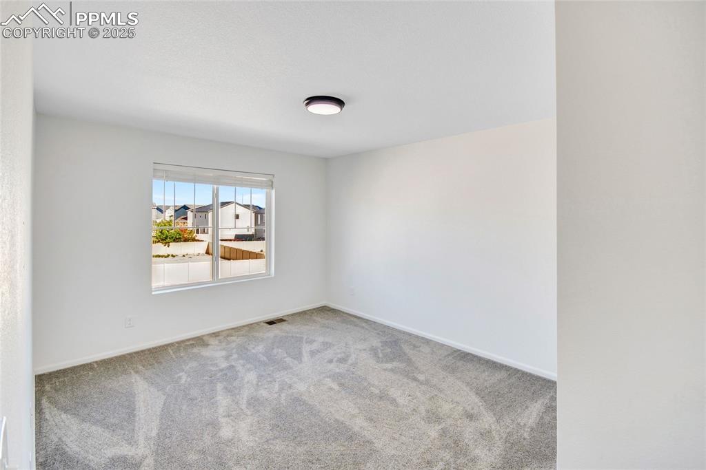 Image 31 of 46: Carpeted spare room with baseboards