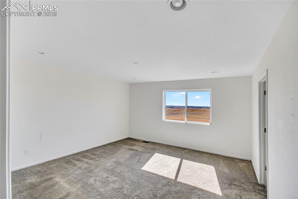 Image 32 of 46: Empty room with carpet and baseboards