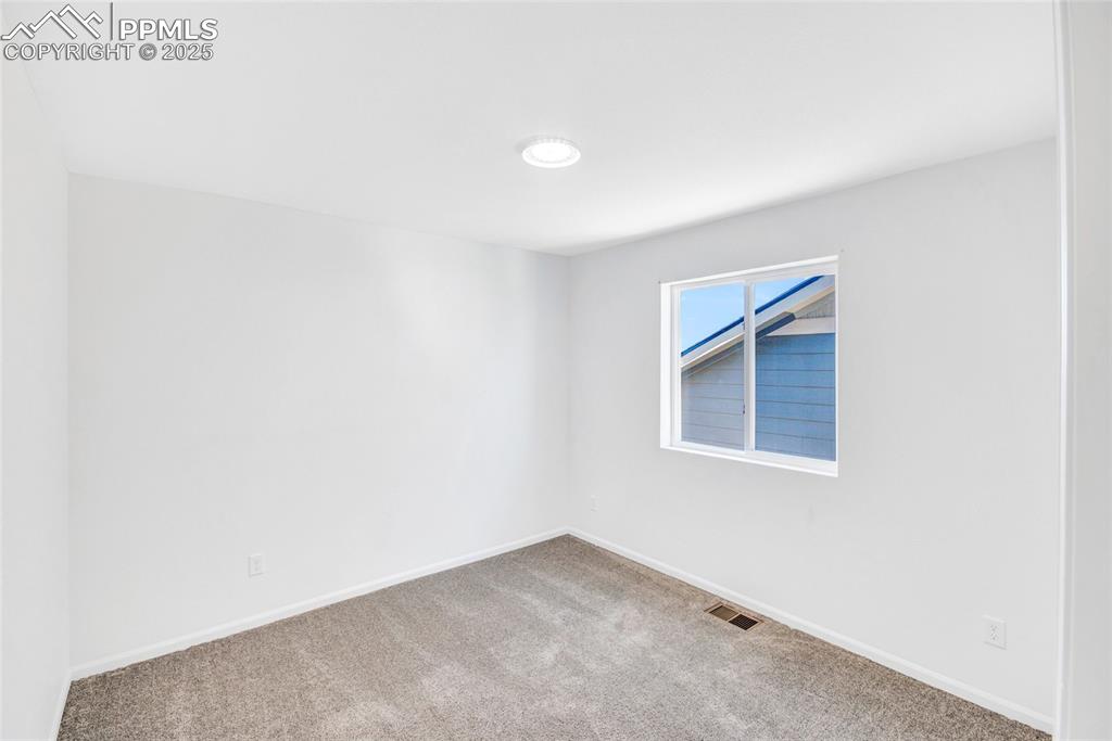 Image 38 of 46: Carpeted spare room featuring baseboards