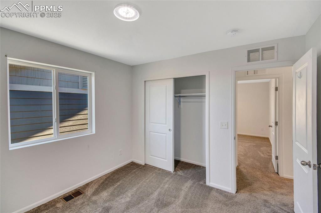 Image 39 of 46: Unfurnished bedroom featuring light carpet and a closet
