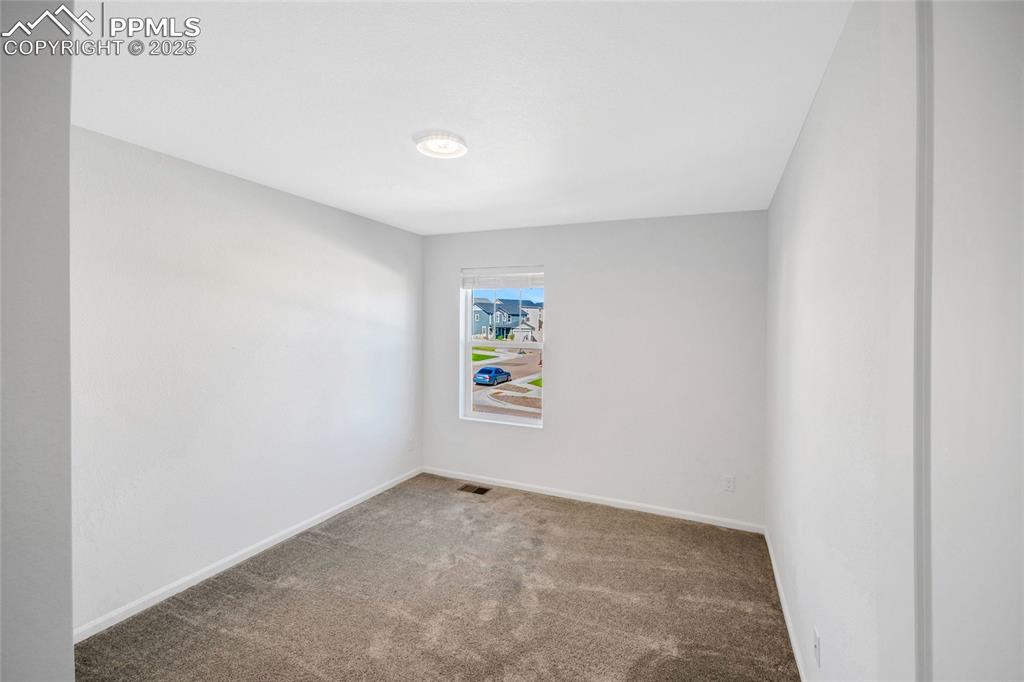 Image 40 of 46: Carpeted spare room with baseboards