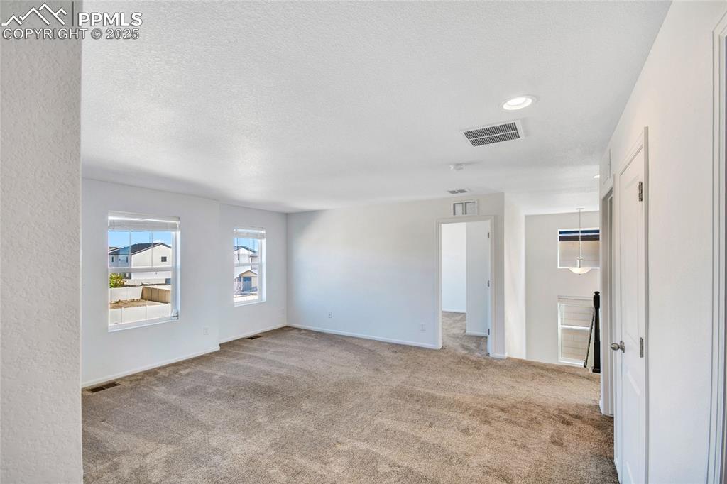 Image 41 of 46: Spare room featuring light carpet and recessed lighting