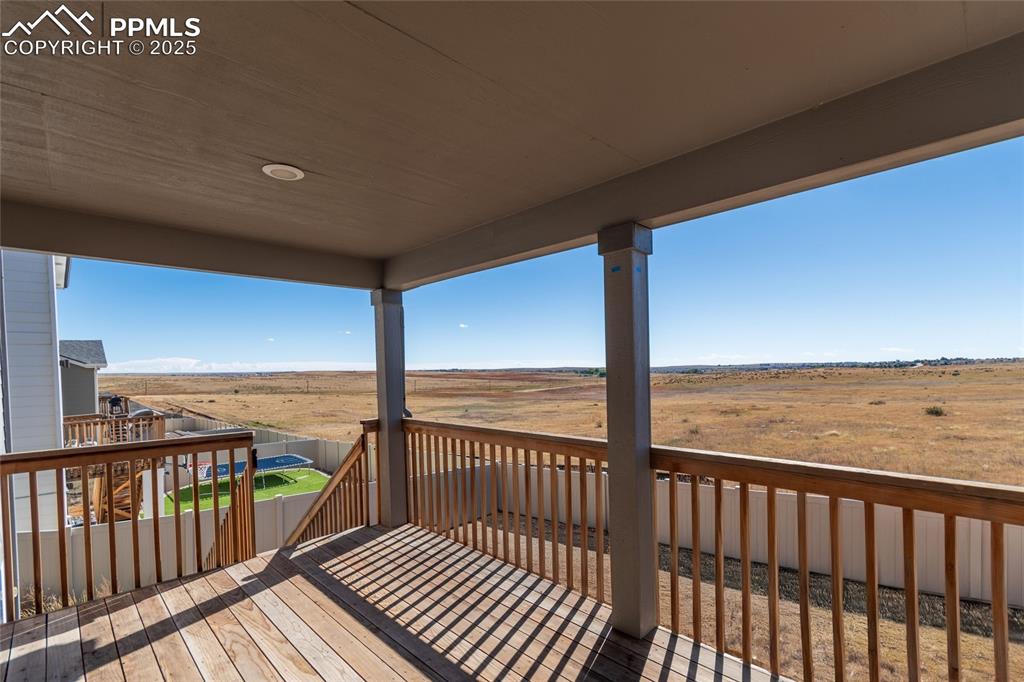 Image 6 of 46: Deck with a fenced backyard and a view of countryside