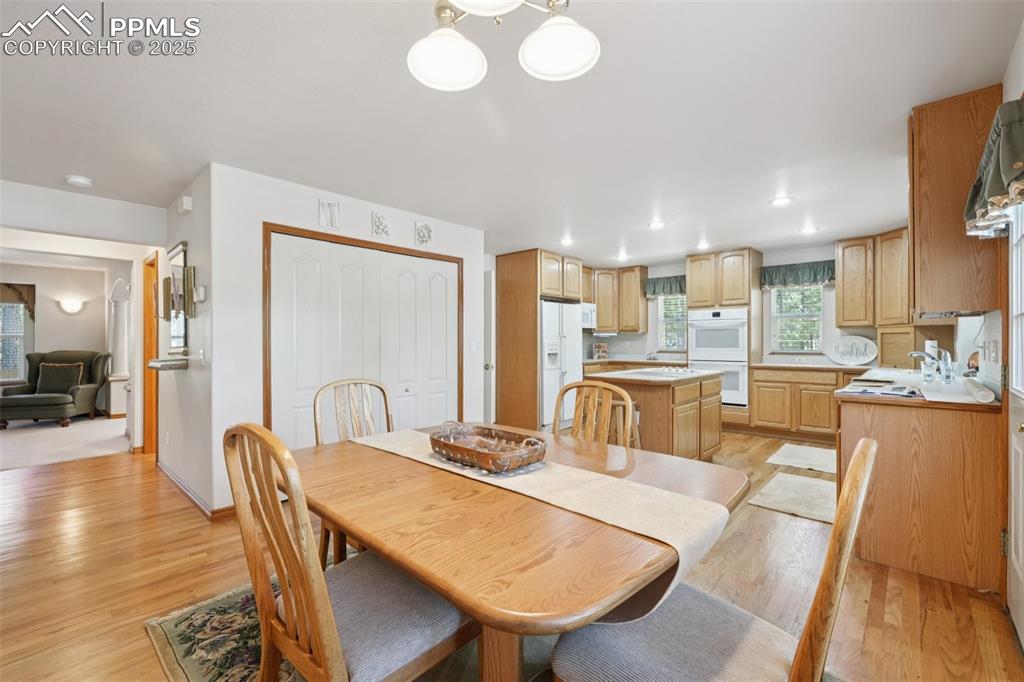 Image 15 of 45: Dining area featuring light wood-type flooring and recessed lighting