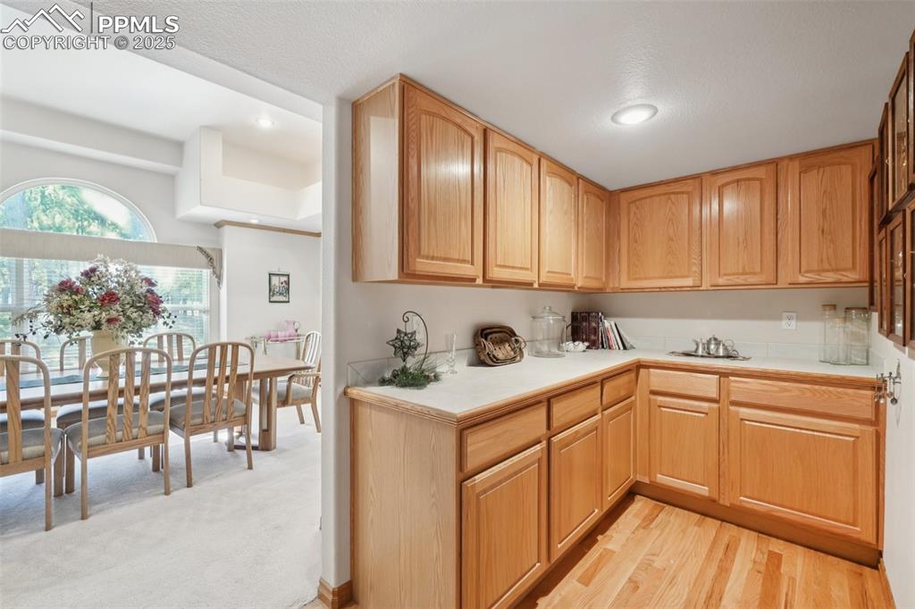 Image 21 of 45: Kitchen featuring light wood-style flooring, light brown cabinets, and rece