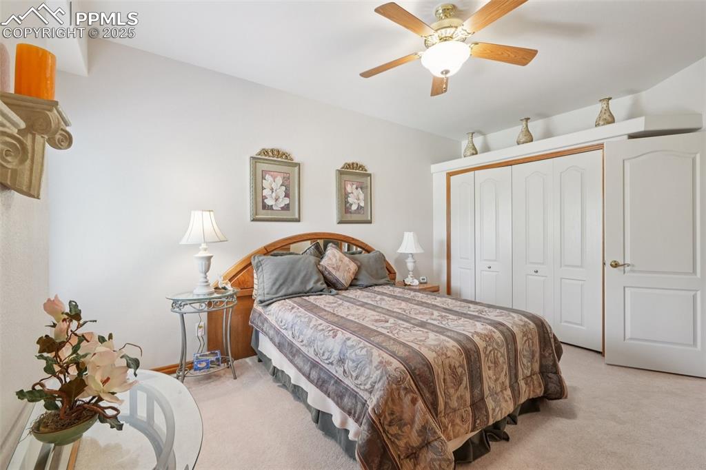Image 33 of 45: Carpeted bedroom featuring ceiling fan and a closet