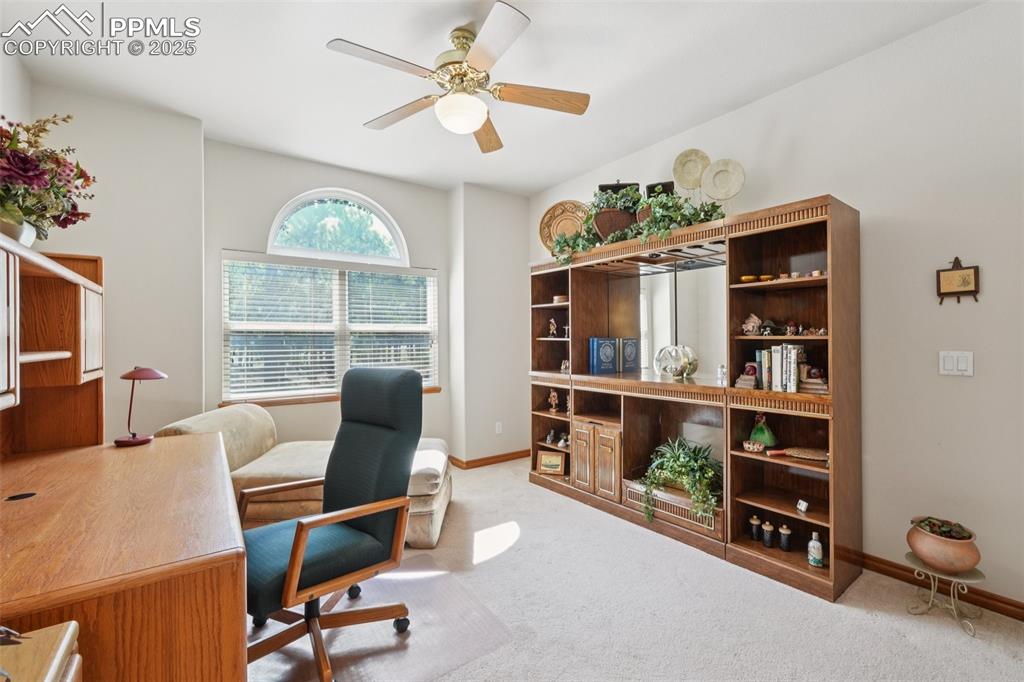Image 34 of 45: Office featuring light colored carpet and ceiling fan