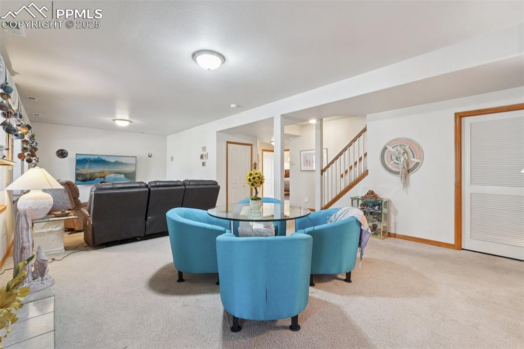 Image 35 of 45: Basement Living room with carpet flooring and stairway