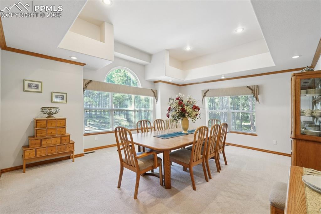 Image 7 of 45: Dining room with carpet flooring, crown molding, recessed lighting, and a r