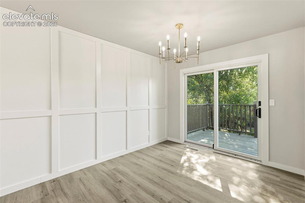 Image 11 of 46: Interior space featuring board and batten wall paneling, a contemporary cha