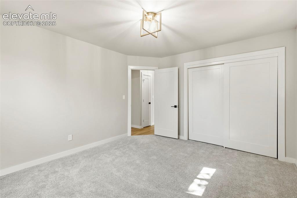 Image 22 of 46: Light gray carpeting underfoot with white baseboards
