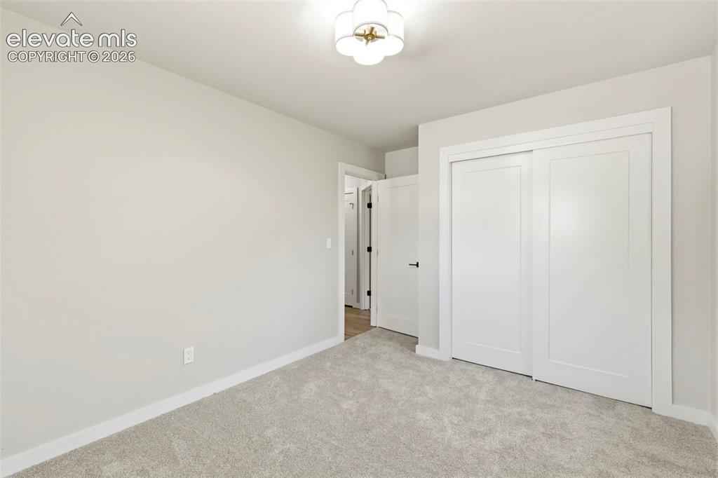 Image 28 of 46: Light-toned walls complement plush carpeting