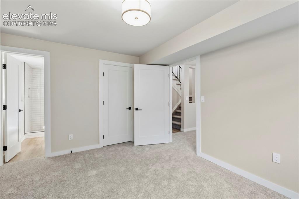 Image 42 of 46: Carpeted room featuring light neutral wall paint and a flush-mount ceiling