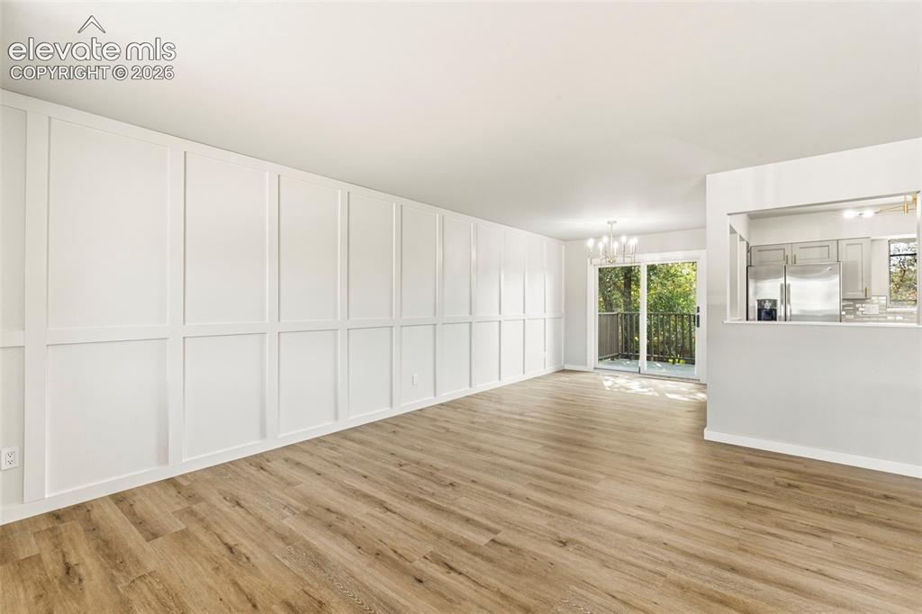 Image 8 of 46: Living area featuring a full wall of decorative paneling, luxury vinyl plan