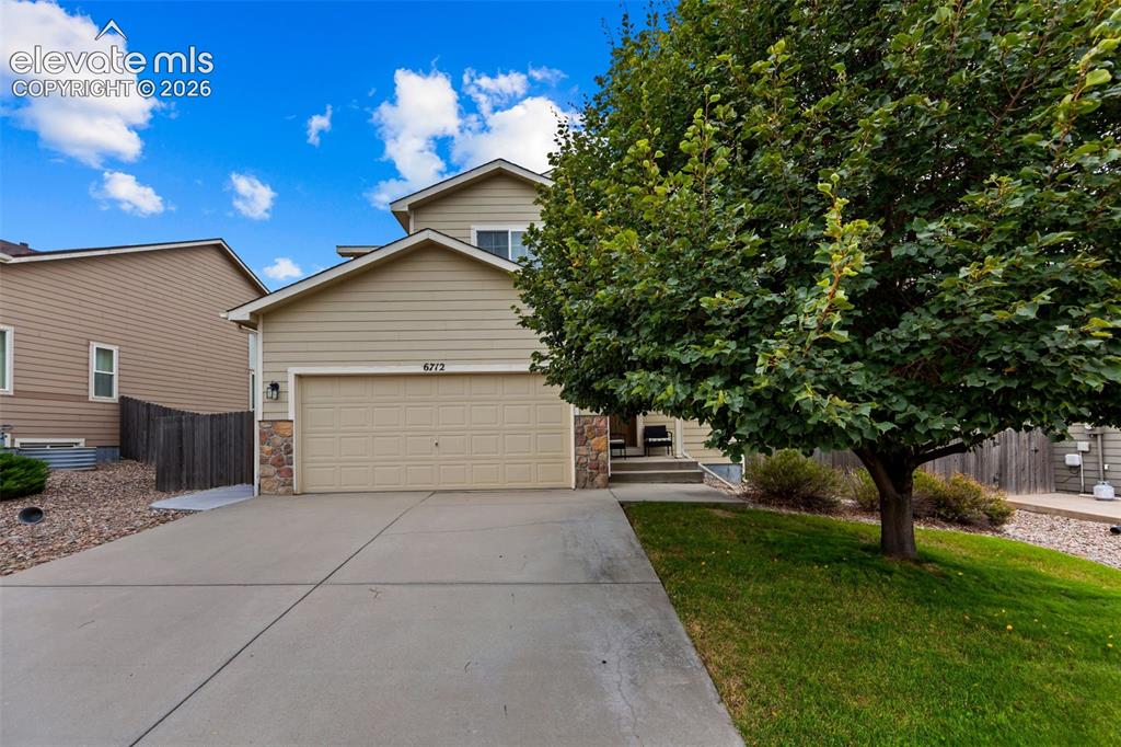 Image 1 of 41: Two-story residence featuring a two-car garage, stone accents, mature front