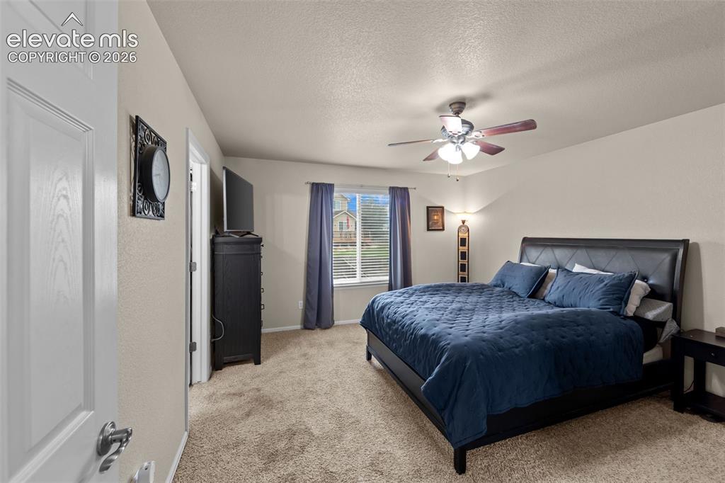 Image 12 of 41: Carpeted interior with neutral wall tones and a window with horizontal blin