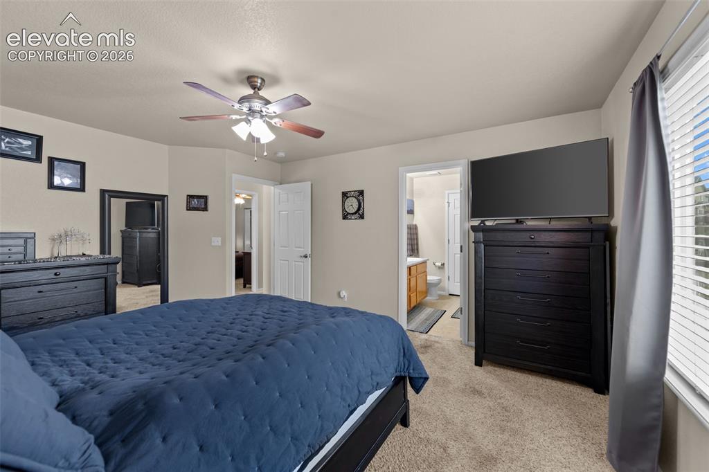 Image 14 of 41: Carpeted flooring, ceiling fan with integrated lighting, window with blinds