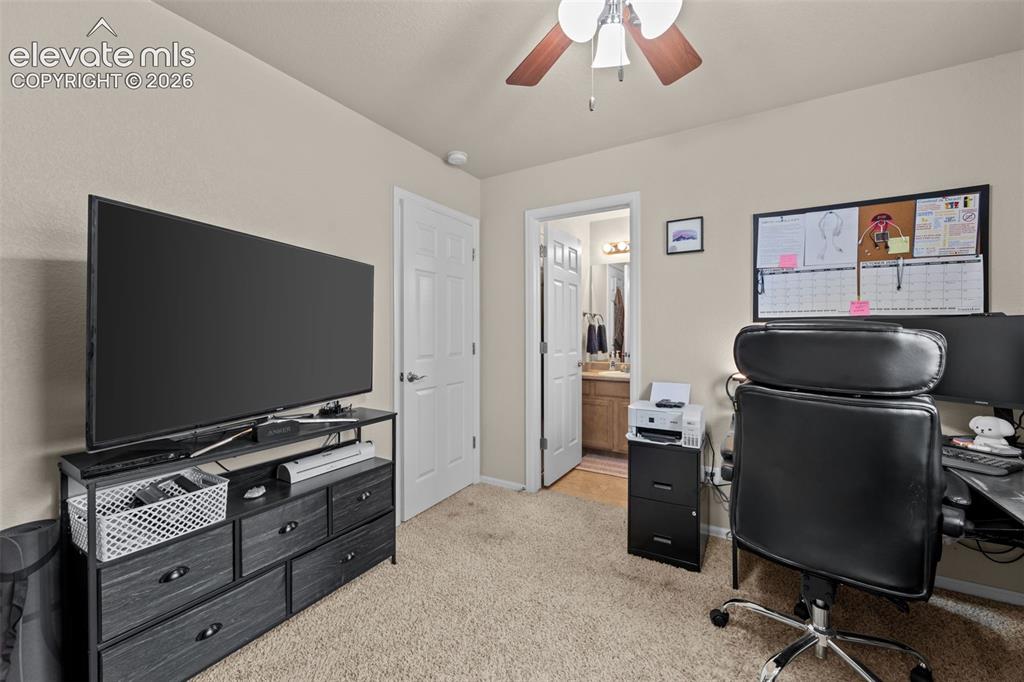 Image 20 of 41: Carpeted flooring, ceiling fan with light fixture, and a white paneled door