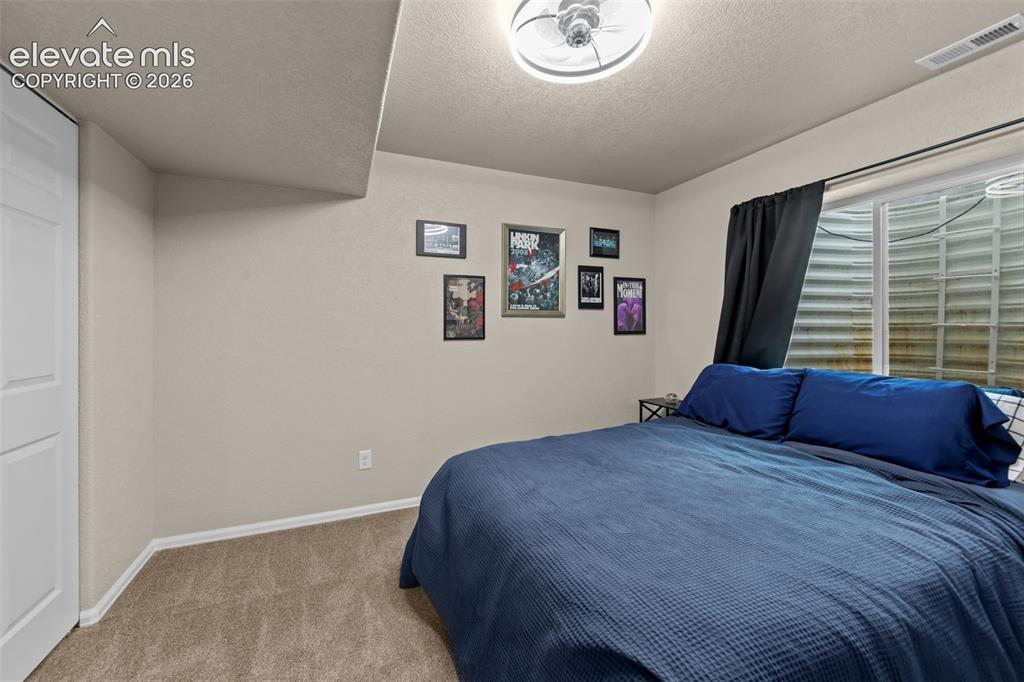 Image 27 of 41: Recessed window with black curtain, ceiling light fixture, and carpeted flo
