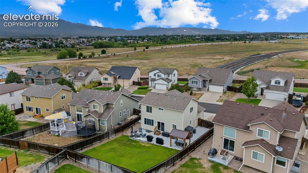 Image 38 of 41: Residential neighborhood with established homes, mountain backdrop, and exp