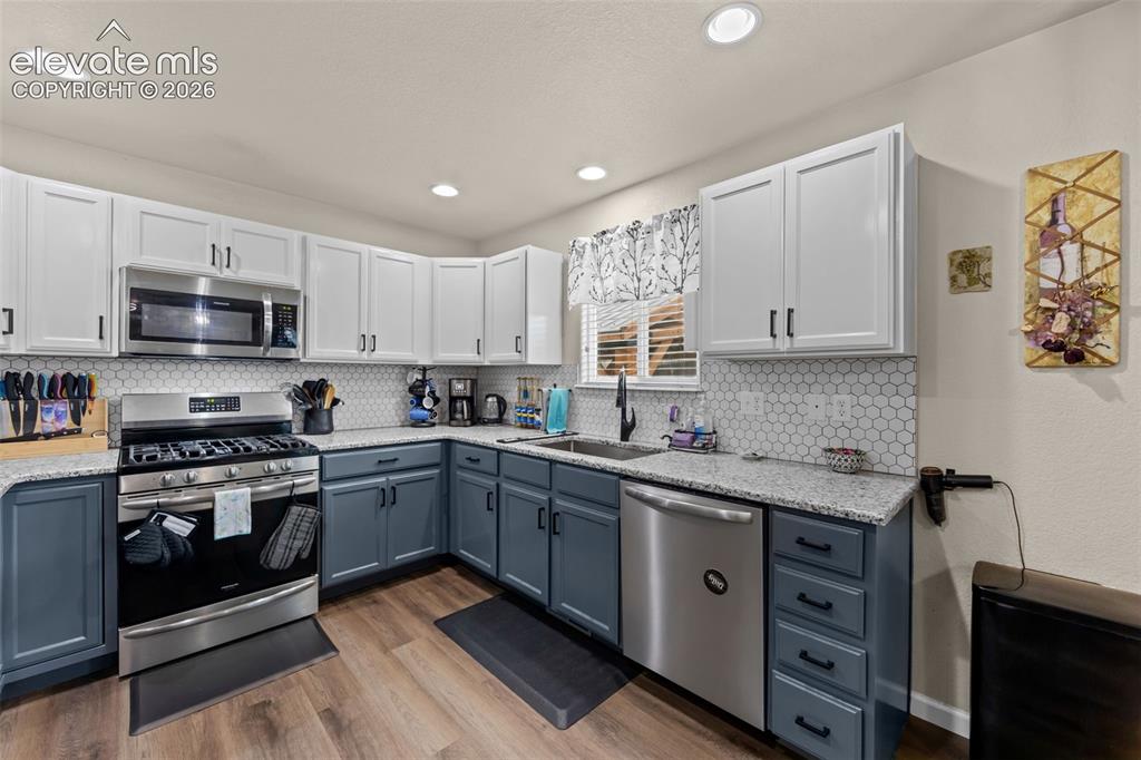 Image 9 of 41: Two-tone cabinetry with contrasting upper and lower units, stainless steel