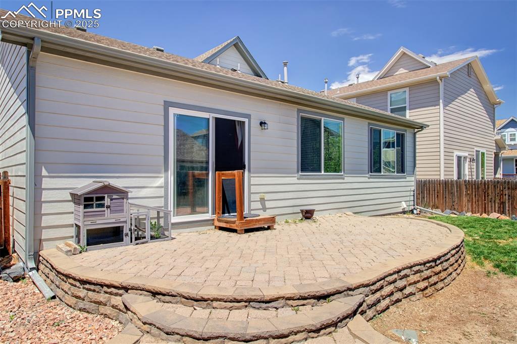 Image 4 of 21: Back of property featuring a patio and roof with shingles